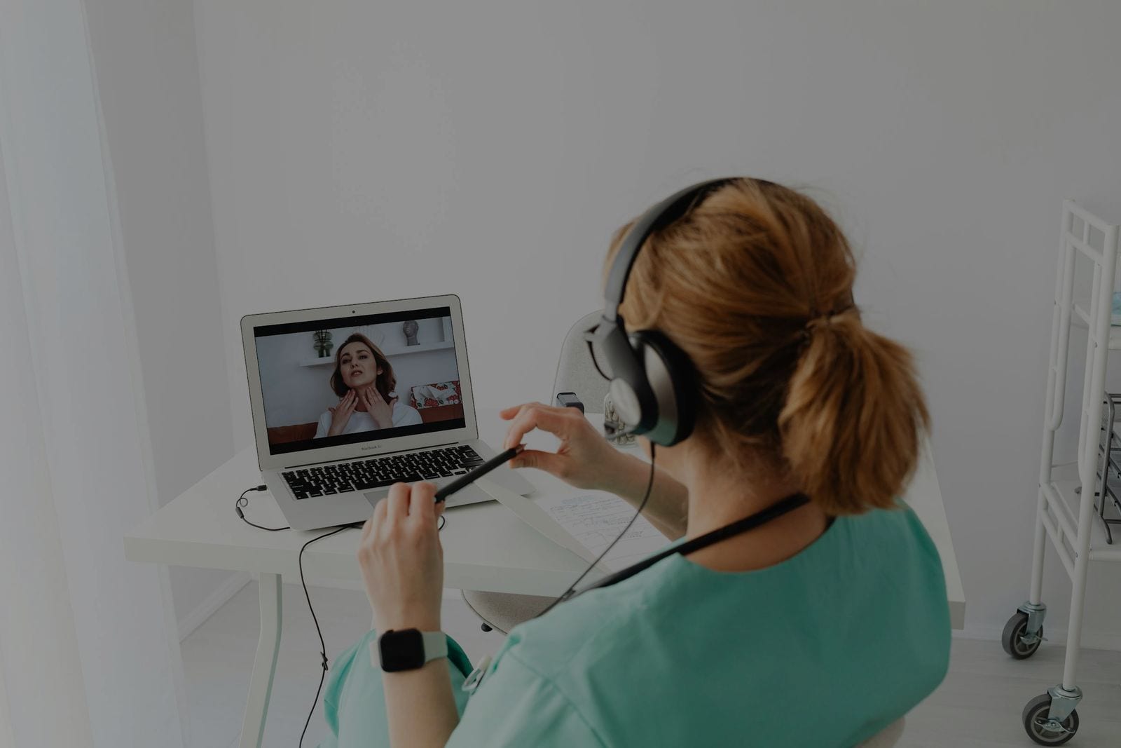 A clinician at a screen — your full dashboard, on their machine.